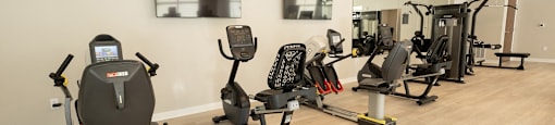 a row of exercise bikes in a gym