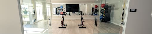 a view of the fitness room with mirrors and exercise equipment