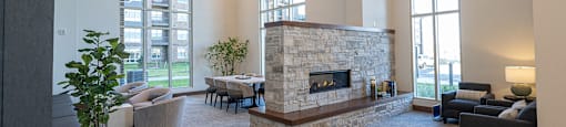 A large lobby area with a stone fireplace and large windows.