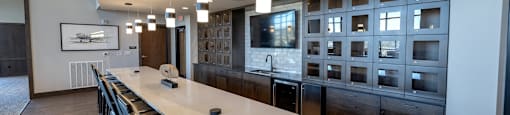 a large kitchen with a long white counter top
