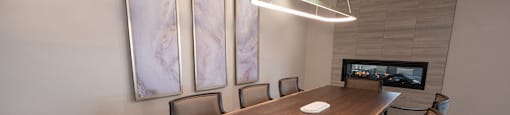 a conference room with a wooden table and chairs
