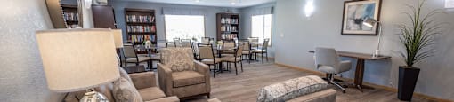 a resident clubhouse with couches chairs and tables
