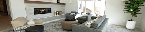 a living room with couches and chairs and a fireplace
