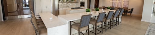 a large kitchen and dining room with a long table and chairs