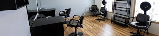 a salon room with chairs and a desk