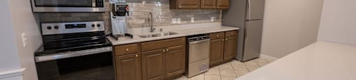 a kitchen with wooden cabinets and a white counter top
