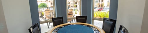 a dining room with a round table and chairs