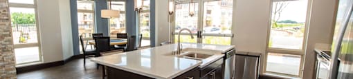 a large kitchen with an island in the middle of it