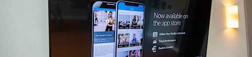 a large screen with a picture of two cell phones on a wall
