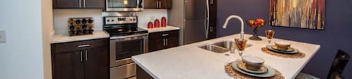 a kitchen with stainless steel appliances and a white counter top