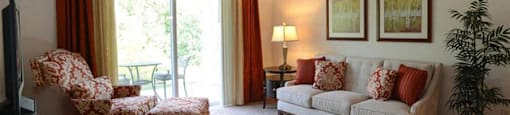 Carpeted Living Rooms With Attached Balconies and Patios at Highlands at Riverwalk Apartments 55+, 10954 N Cedarburg Road