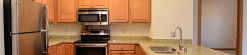 Gourmet Kitchens with Islands, Caesarstone Countertops, and Decorative Backsplash at Highlands at Riverwalk Apartments 55+, Mequon, 53092