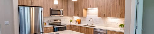 a kitchen with stainless steel appliances and a white counter top