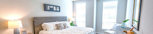 a bedroom with a large bed and a ceiling fan