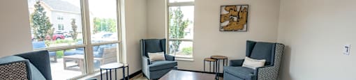 a living room with couches and chairs and a table