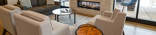 a living room with couches and chairs and a fireplace