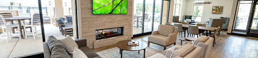a living room with couches and chairs and a fireplace