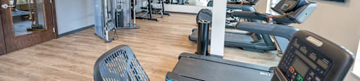 a gym with cardio machines and other exercise equipment