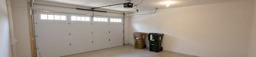 a garage with white walls and a white garage door