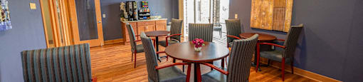 a dining room with a table and chairs and a kitchen