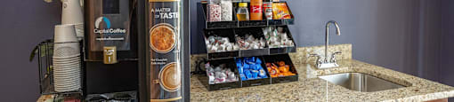 a kitchen counter with a refrigerator and a sink