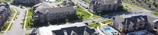 Paragon Place at Bear Claw Way aerial view of property site and pool