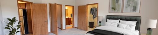 a large bedroom with a bed and a ceiling fan