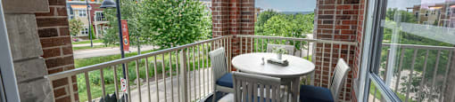 a patio with a table and chairs on a balcony
