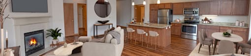 a living room with a fireplace and a dining room and kitchen