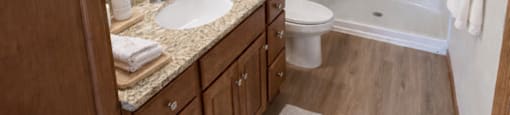 A bathroom with a sink, toilet, and shower.