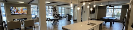 an open living room with a kitchen and dining area