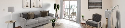 a living room with white walls and a sliding glass door leading to a balcony