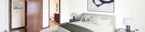 a bedroom with a large bed and a ceiling fan