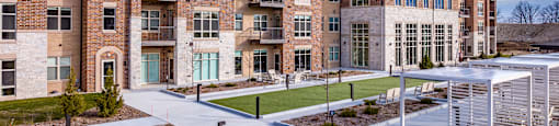 apartment building with outdoor lounge and game areas
