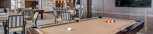 a clubhouse with a pool table and a tv