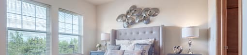 a bedroom with a bed and a ceiling fan