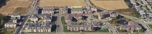 an aerial view of a city with houses and a field