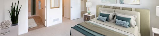 a bedroom with a large bed and a ceiling fan