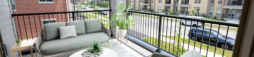 a living room with couches and a table on a balcony