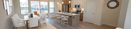 an open living room and kitchen with a dining room table and chairs
