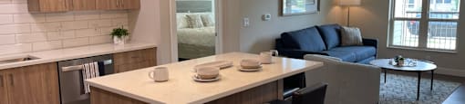 an open floor plan with a kitchen island and a living room with a couch and coffee table