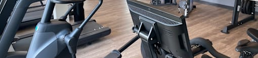 a gym with treadmills and other exercise equipment