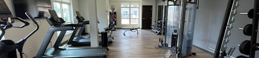 a room filled with lots of different types of exercise equipment