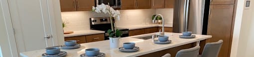 a kitchen with a large island and a bunch of blue chairs