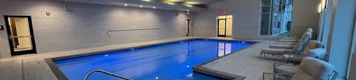 A large indoor swimming pool with a staircase leading down to it.