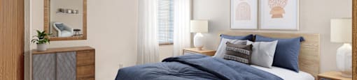 A bedroom with a bed, nightstand, and a ceiling fan.