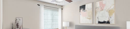 A bedroom with a bed, dresser, and ceiling fan.