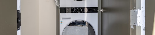 A white LG washing machine and dryer in a small laundry room.