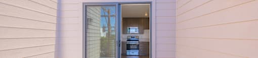A modern house with a glass door entrance.