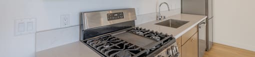 A modern kitchen with a stainless steel stove and microwave.